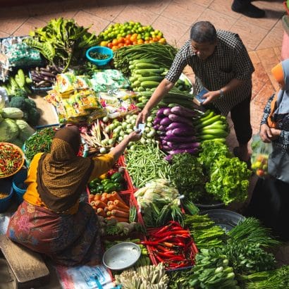 person standing near vegetables